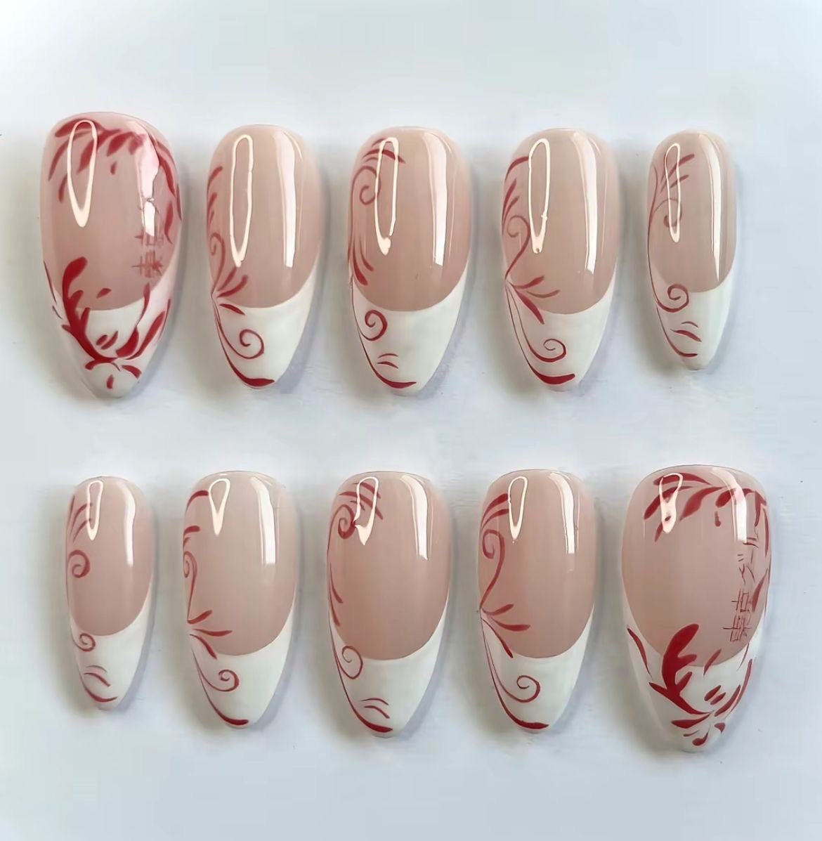 Nude French Tip Press-On Nails – Red Abstract Swirl Hand-Painted Glossy Almond Set